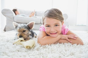 kid and dog laying down